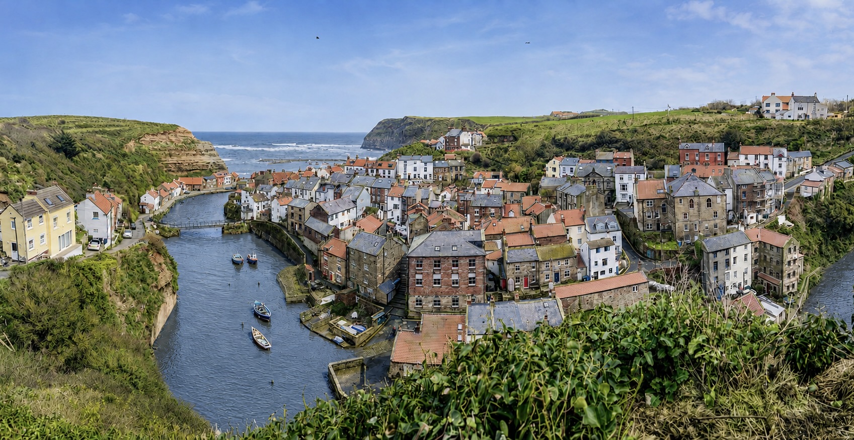Staithes harbour and the red-roofed old village between the cliffs